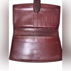 vintage Coach bifold wallet made of brown leather.
